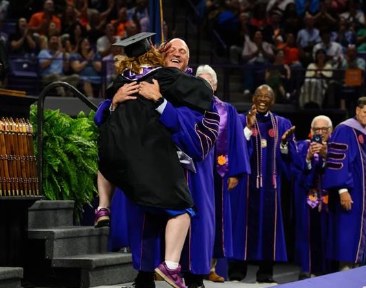grace hugs dad at graduation